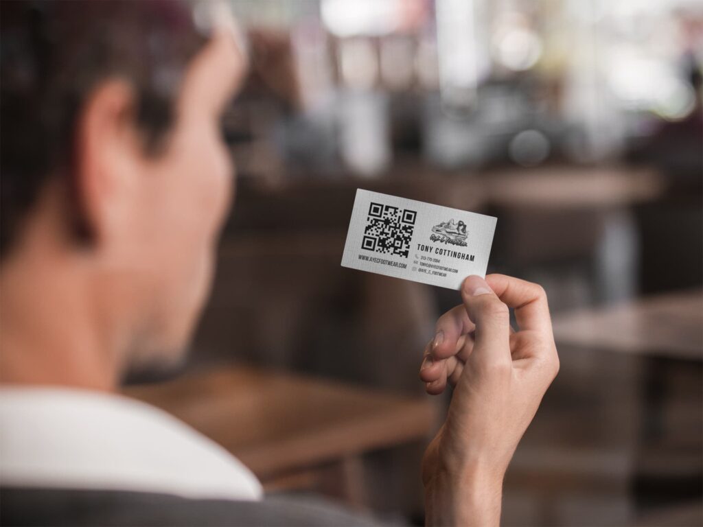 A First Hill Marketing branded business card with a QR code